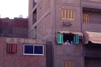 Family standing on the balcony watching the preparing of the iftar, Ramadan Kareem, preparing their iftar