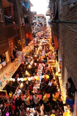 View of people in Matareya sharing their iftar together in the street, Ramadan Kareem, preparing their iftar