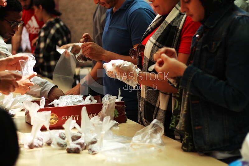 View of people in Matareya sharing their iftar together in the street, Ramadan Kareem, preparing their iftar