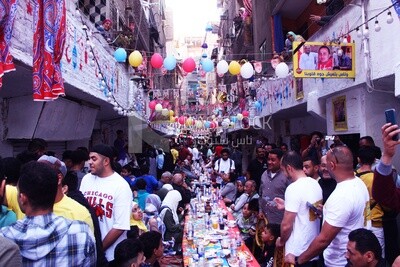 View of people in Matareya sharing their iftar together in the street, Ramadan Kareem, preparing their iftar