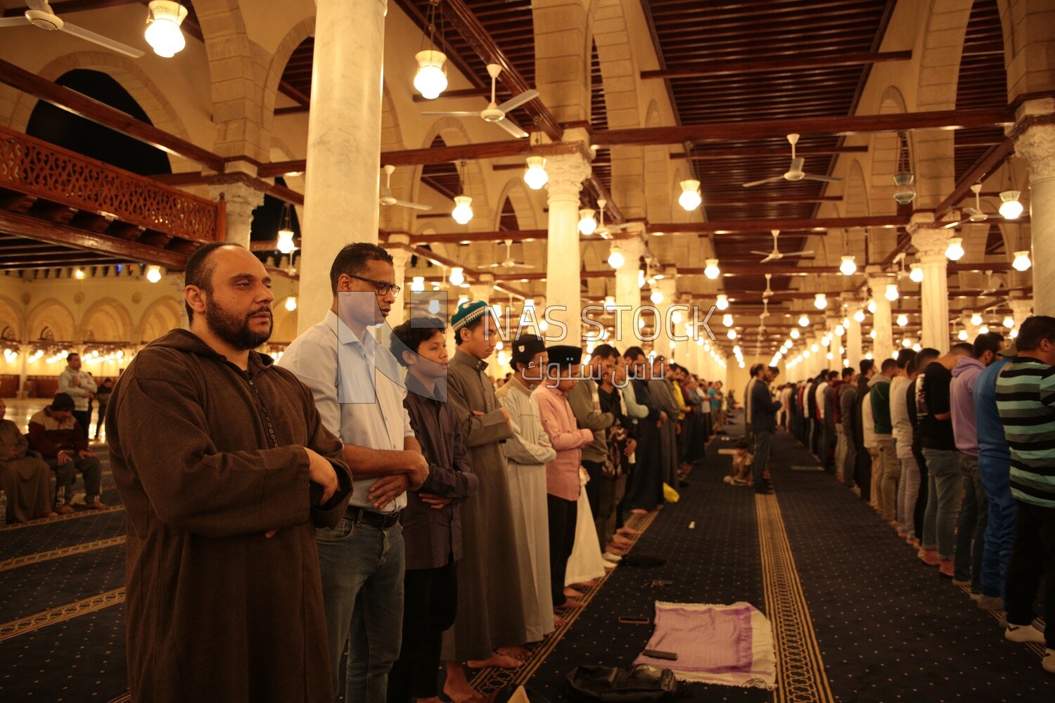 Worshipers praying in a mosque, performing the obligatory prayer in the mosque, worship and draw close to God