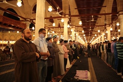 Worshipers praying in a mosque, performing the obligatory prayer in the mosque, worship and draw close to God