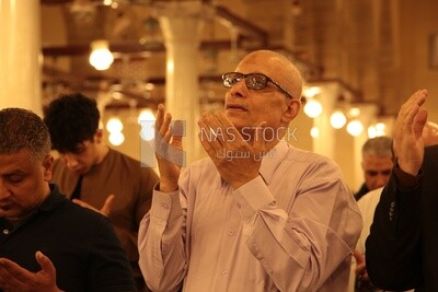 Man in the mosque, praying on the prayer rug, performing the obligatory prayer in the mosque, worship and draw close to God