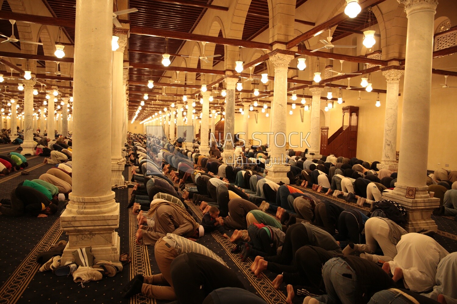 Worshipers praying in a mosque, performing the obligatory prayer in the mosque, worship and draw close to God