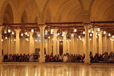 Worshipers praying in a mosque, performing the obligatory prayer in the mosque, worship and draw close to God