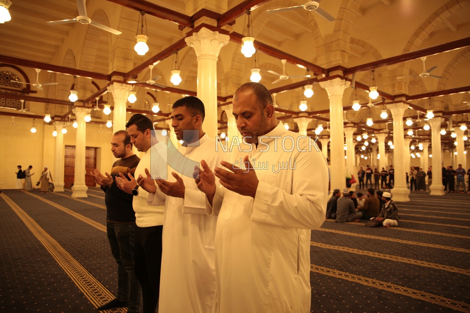 Worshipers praying in a mosque, performing the obligatory prayer in the mosque, worship and draw close to God