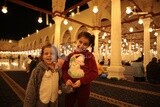 Two girls standing in a mosque, performing the obligatory prayer in the mosque, worship and draw close to God