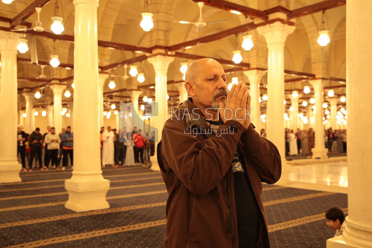 Man in the mosque, praying to God, praying on the prayer rug, performing the obligatory prayer in the mosque, worship and draw close to God