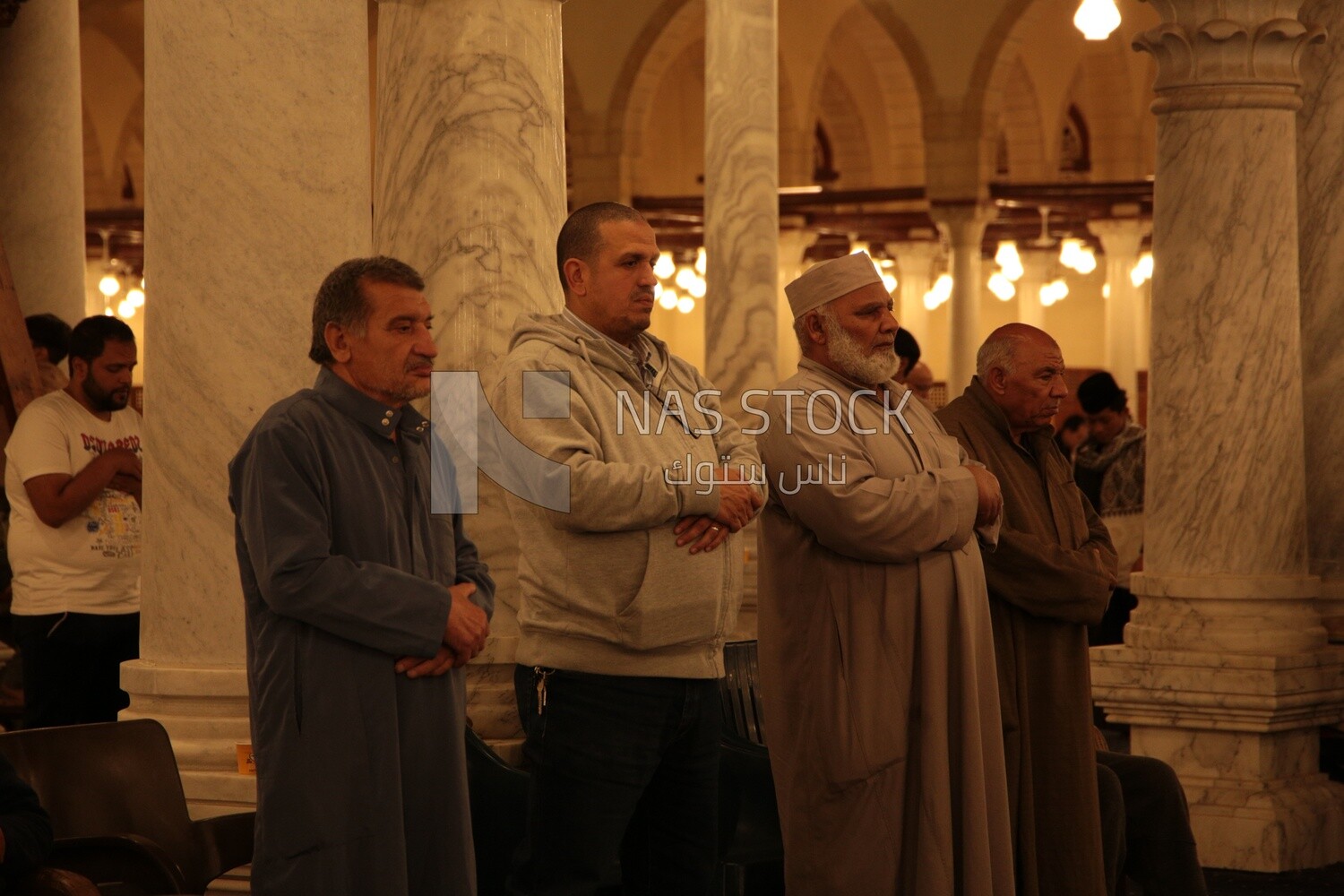 Worshipers praying in a mosque, performing the obligatory prayer in the mosque, worship and draw close to God