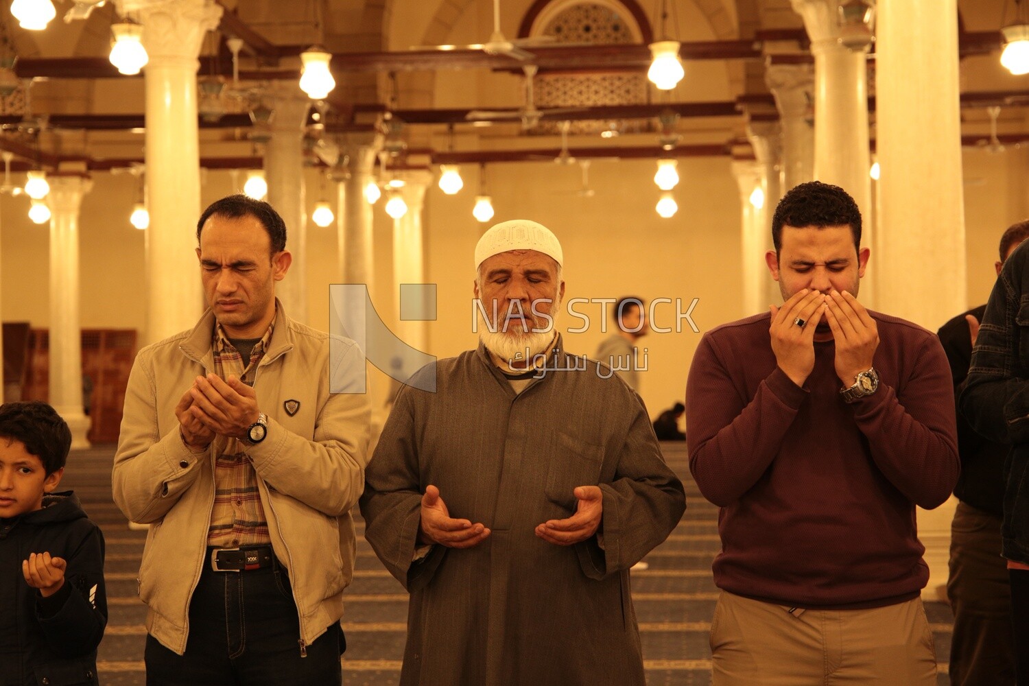 Worshipers praying in a mosque, performing the obligatory prayer in the mosque, worship and draw close to God
