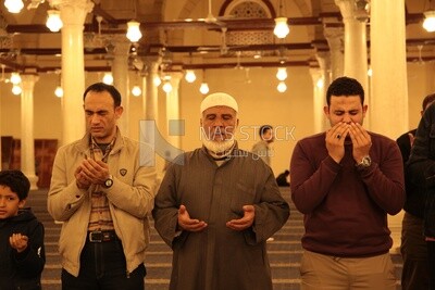 Worshipers praying in a mosque, performing the obligatory prayer in the mosque, worship and draw close to God
