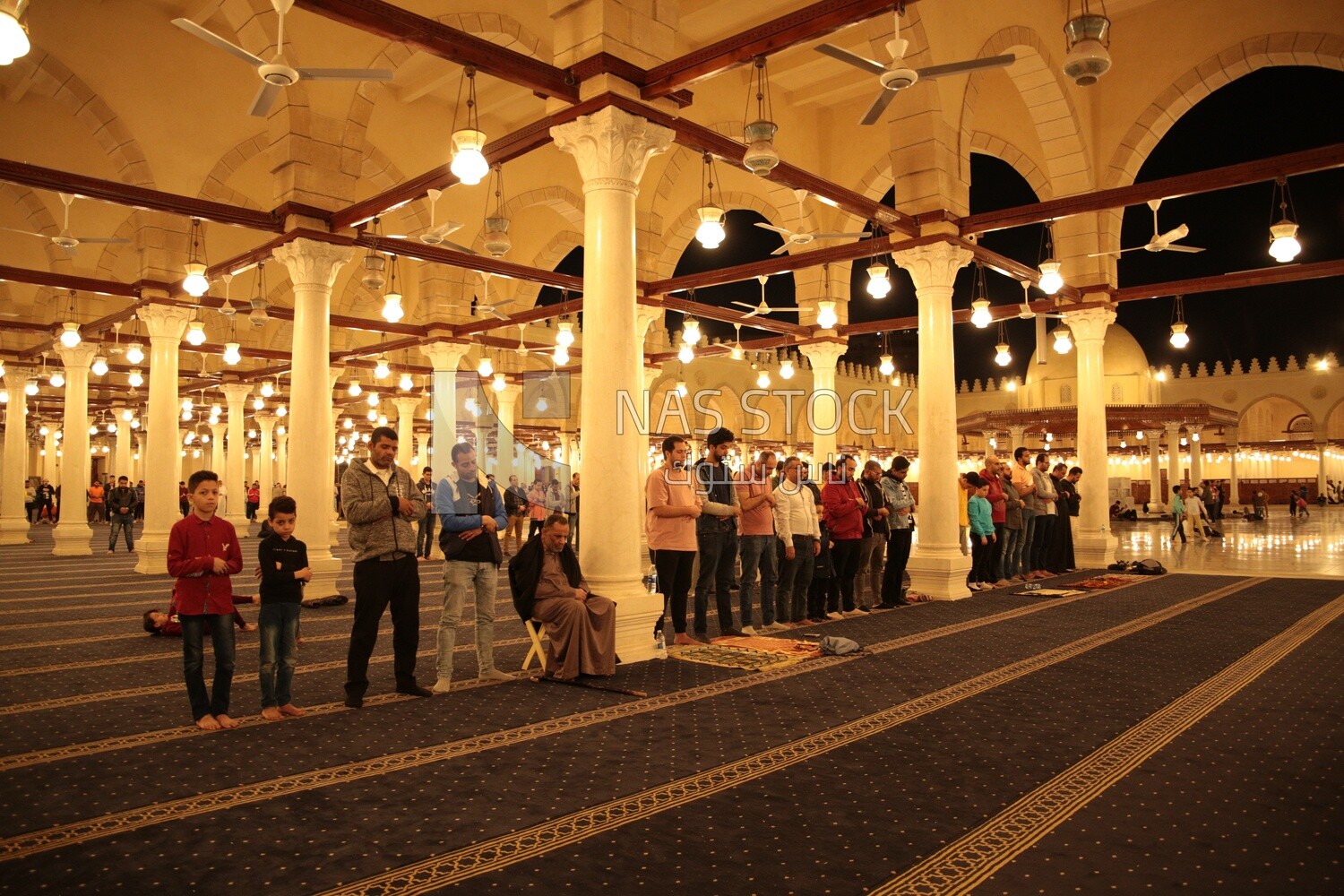 Worshipers praying in a mosque, performing the obligatory prayer in the mosque, worship and draw close to God