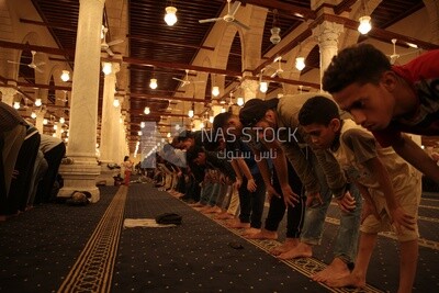 Worshipers praying in a mosque, performing the obligatory prayer in the mosque, worship and draw close to God