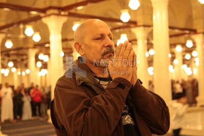 Man in the mosque, praying on the prayer rug, performing the obligatory prayer in the mosque, worship and draw close to God