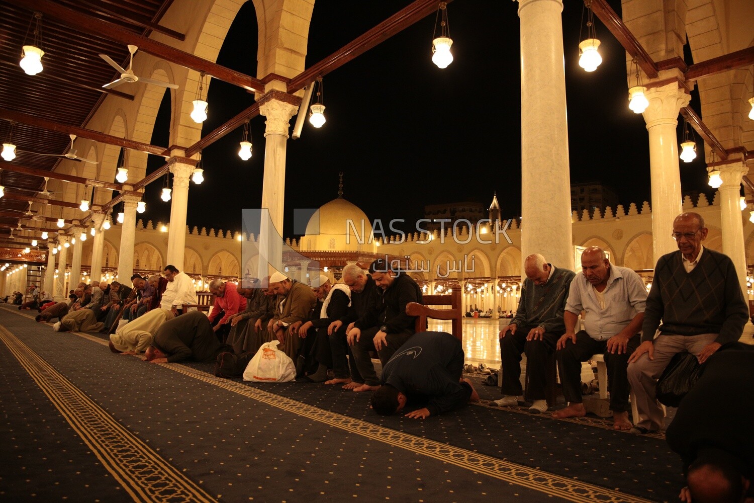 Worshipers praying in a mosque, performing the obligatory prayer in the mosque, worship and draw close to God