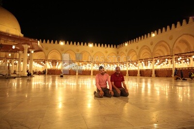Worshipers praying in a mosque, performing the obligatory prayer in the mosque, worship and draw close to God
