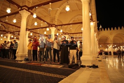 Worshipers praying in a mosque, performing the obligatory prayer in the mosque, worship and draw close to God