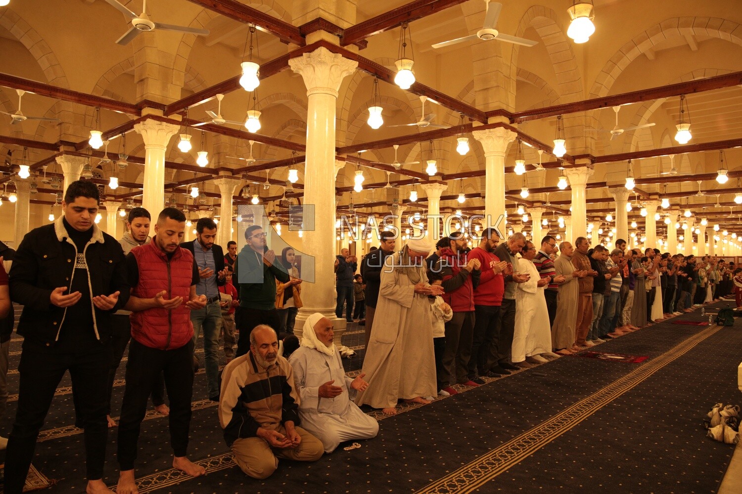 Worshipers praying in a mosque, performing the obligatory prayer in the mosque, worship and draw close to God