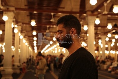 Man in the mosque, praying to God, praying on the prayer rug, performing the obligatory prayer in the mosque, worship and draw close to God