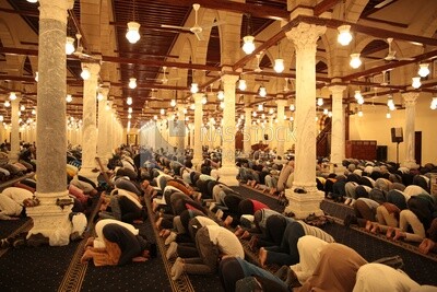 Worshipers praying in a mosque, performing the obligatory prayer in the mosque, worship and draw close to God