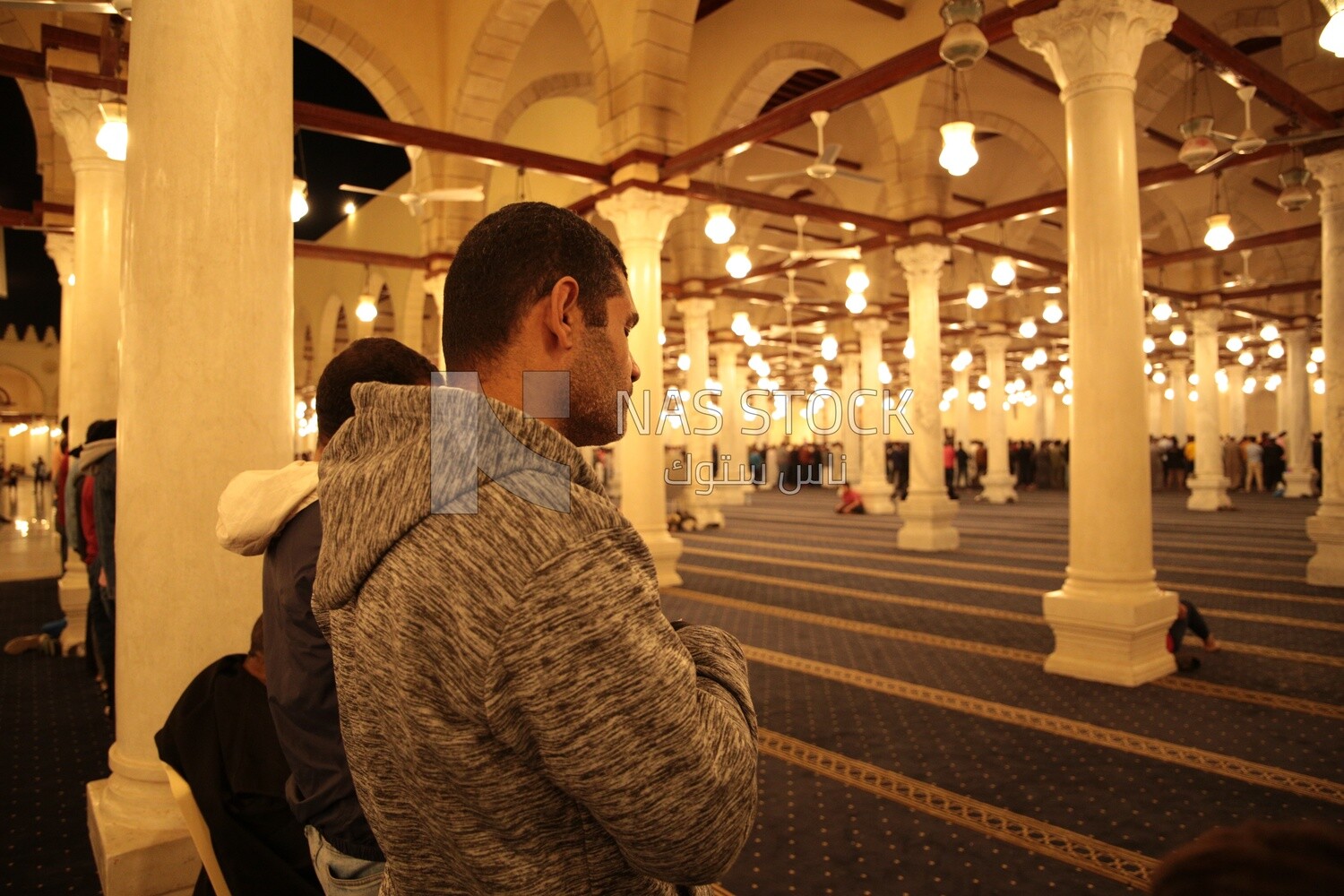 Worshipers praying in a mosque, performing the obligatory prayer in the mosque, worship and draw close to God