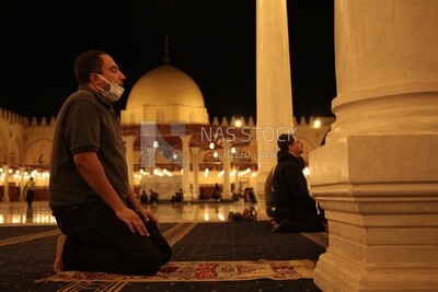 Man in the mosque, praying to God, praying on the prayer rug, performing the obligatory prayer in the mosque, worship and draw close to God