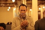 Man in the mosque, praying to God, praying on the prayer rug, performing the obligatory prayer in the mosque, worship and draw close to God