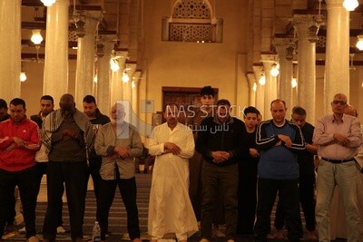 Worshipers praying in a mosque, performing the obligatory prayer in the mosque, worship and draw close to God