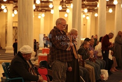 Worshipers praying in a mosque, performing the obligatory prayer in the mosque, worship and draw close to God