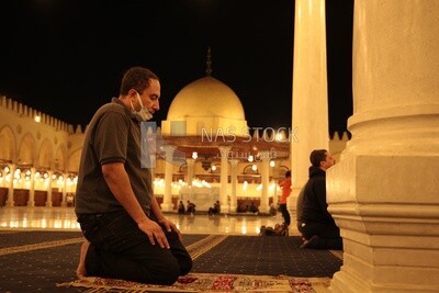 Man in the mosque, praying to God, praying on the prayer rug, performing the obligatory prayer in the mosque, worship and draw close to God