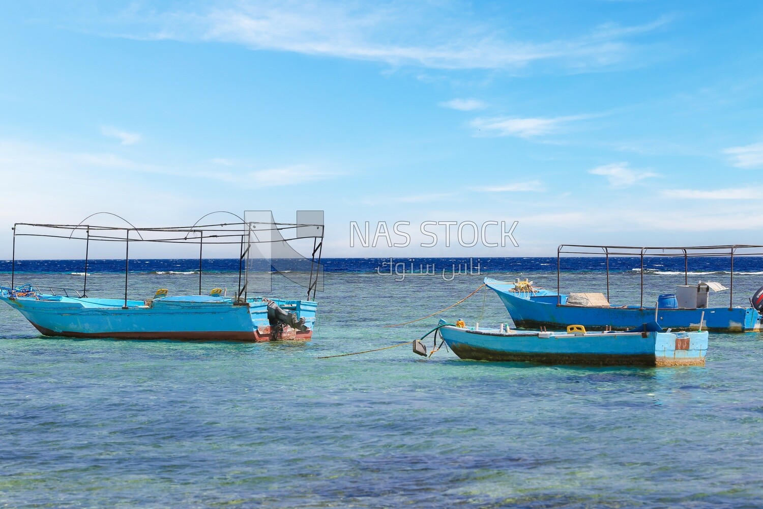Group of wooden boats moored in the waters