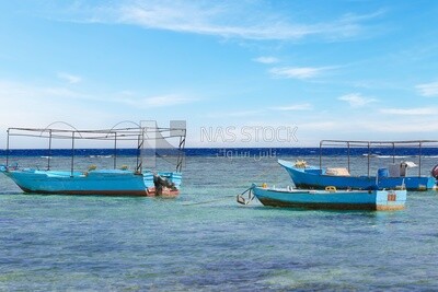 Group of wooden boats moored in the waters
