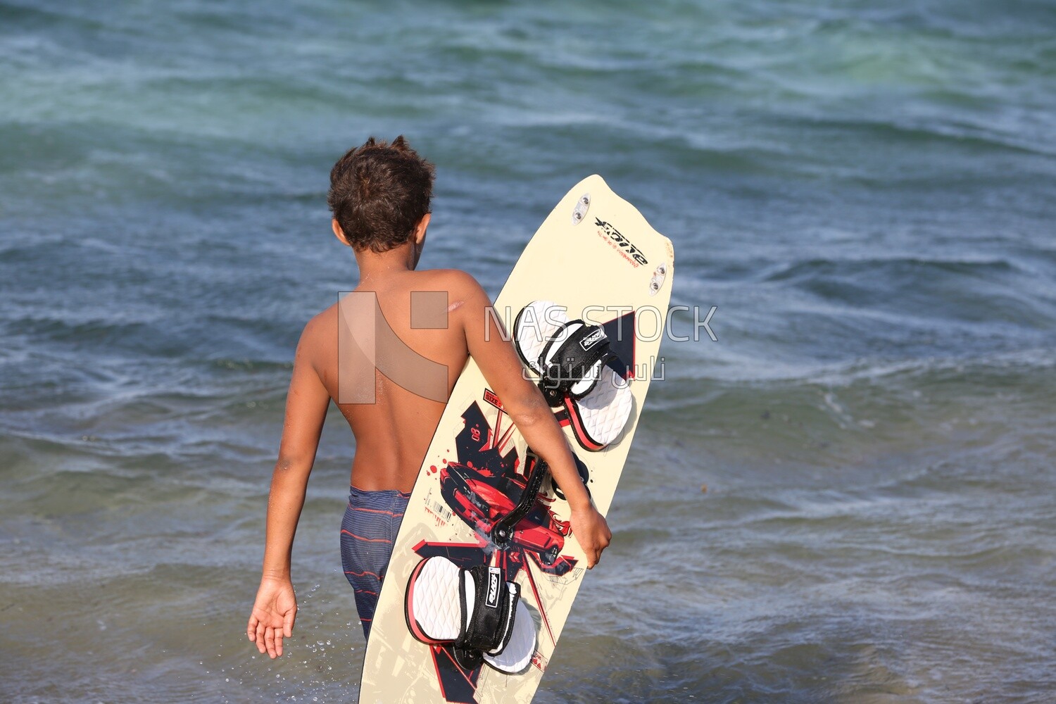 Child carries a skateboard
