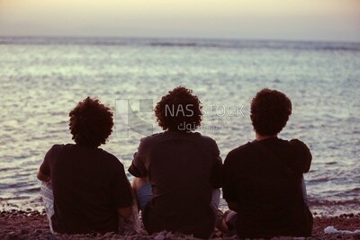 Group of friends sitting on the beach