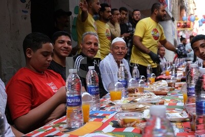 View of people in Matareya sharing their iftar together in the street, Ramadan Kareem, preparing their iftar
