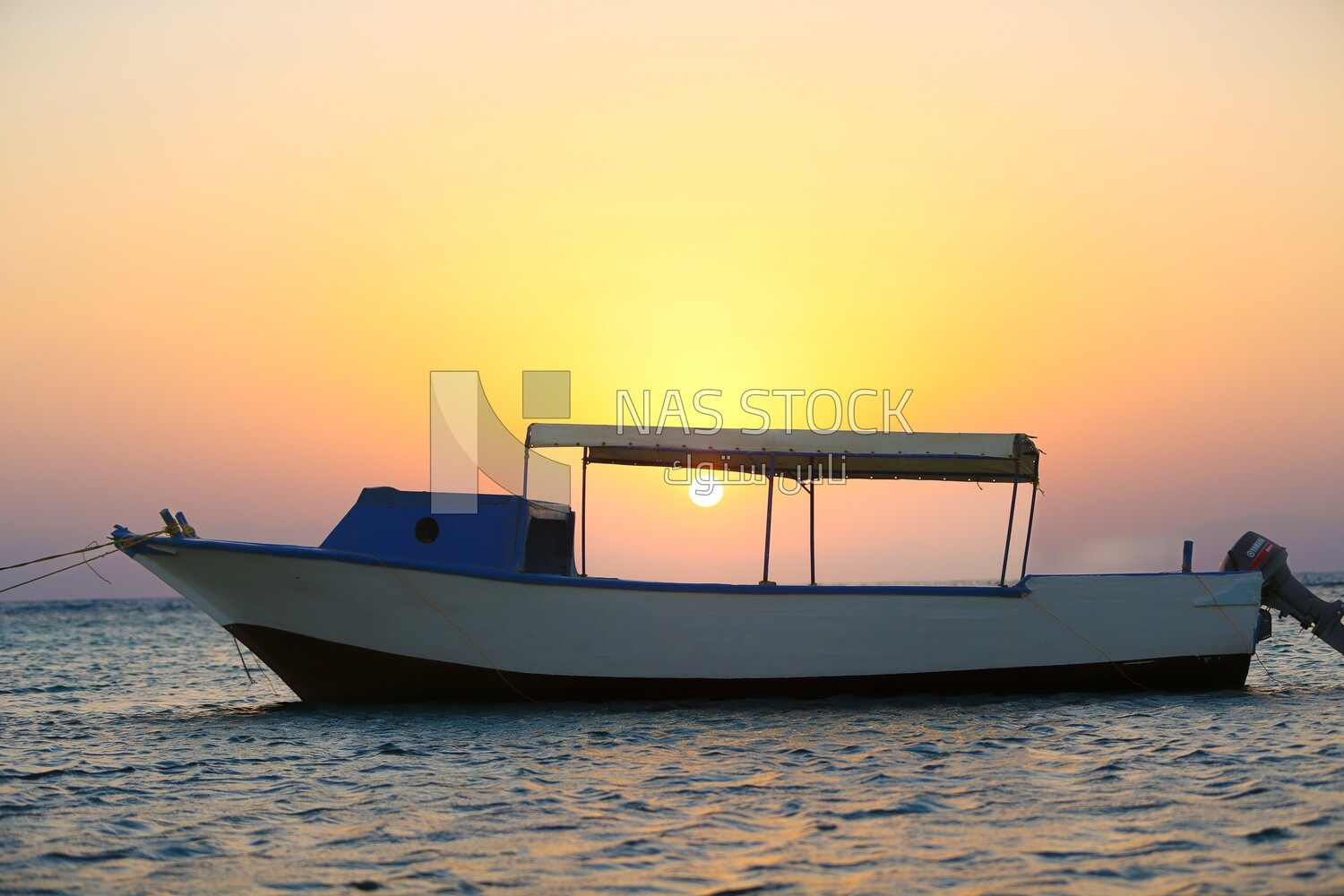 Wooden boat anchored in the Red Sea at sunset