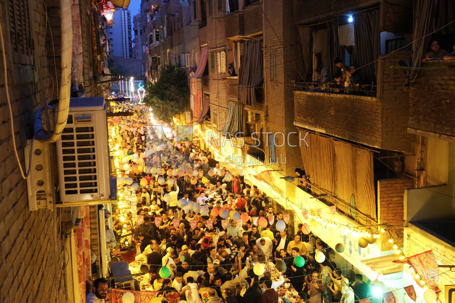 Top view of people in Matareya sharing their iftar together in the street, Ramadan Kareem, preparing their iftar
