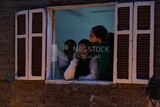 Women standing on the balcony watching the preparing of the iftar, Ramadan Kareem, preparing their iftar