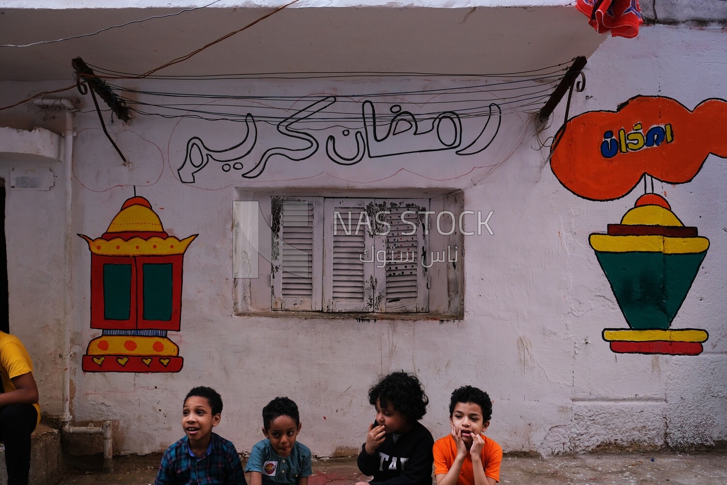Boys sitting in the street, Matareya sharing their iftar together in the street, Ramadan Kareem, preparing their iftar