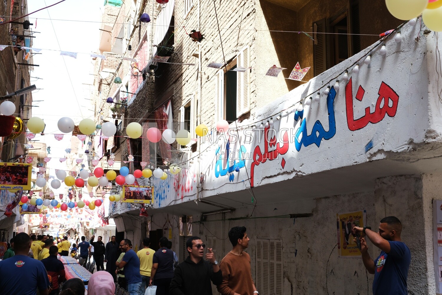 View of people in Matareya sharing their iftar together in the street, Ramadan Kareem, preparing their iftar