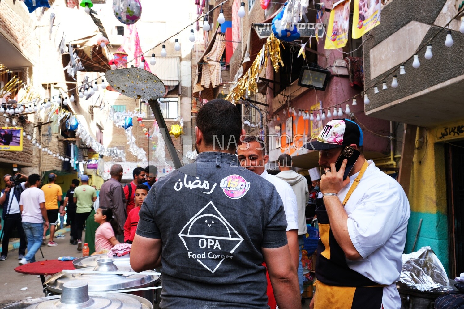 View of people in Matareya sharing their iftar together in the street, Ramadan Kareem, preparing their iftar