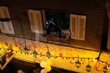 Old woman sitting on the balcony watching the preparing of the iftar, Ramadan Kareem, preparing their iftar