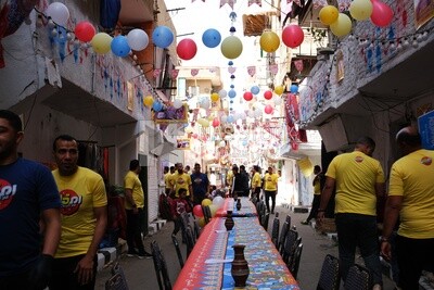 View of people in Matareya sharing their iftar together in the street, Ramadan Kareem, preparing their iftar