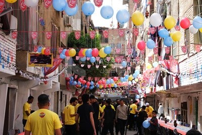 View of people in Matareya sharing their iftar together in the street, Ramadan Kareem, preparing their iftar