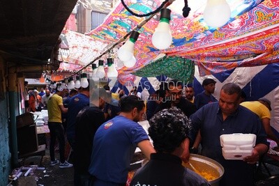 View of people in Matareya sharing their iftar together in the street, Ramadan Kareem, preparing their iftar