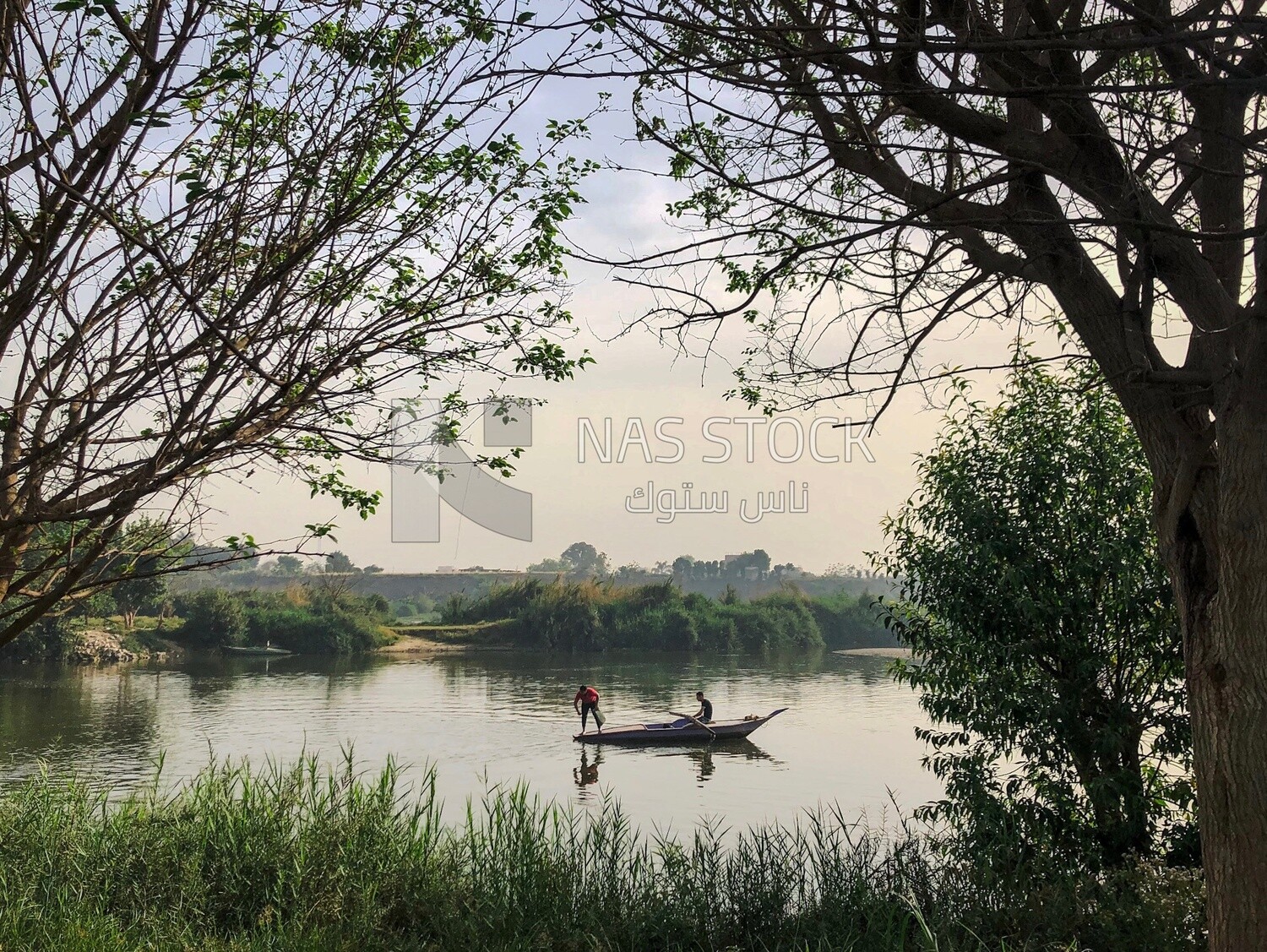 Two fishermen on a fishing boat in the Nile River, Egypt