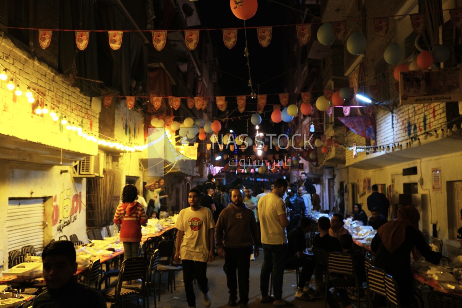 View of people in Matareya sharing their iftar together in the street, Ramadan Kareem, preparing their iftar