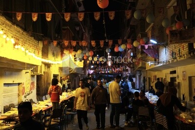 View of people in Matareya sharing their iftar together in the street, Ramadan Kareem, preparing their iftar