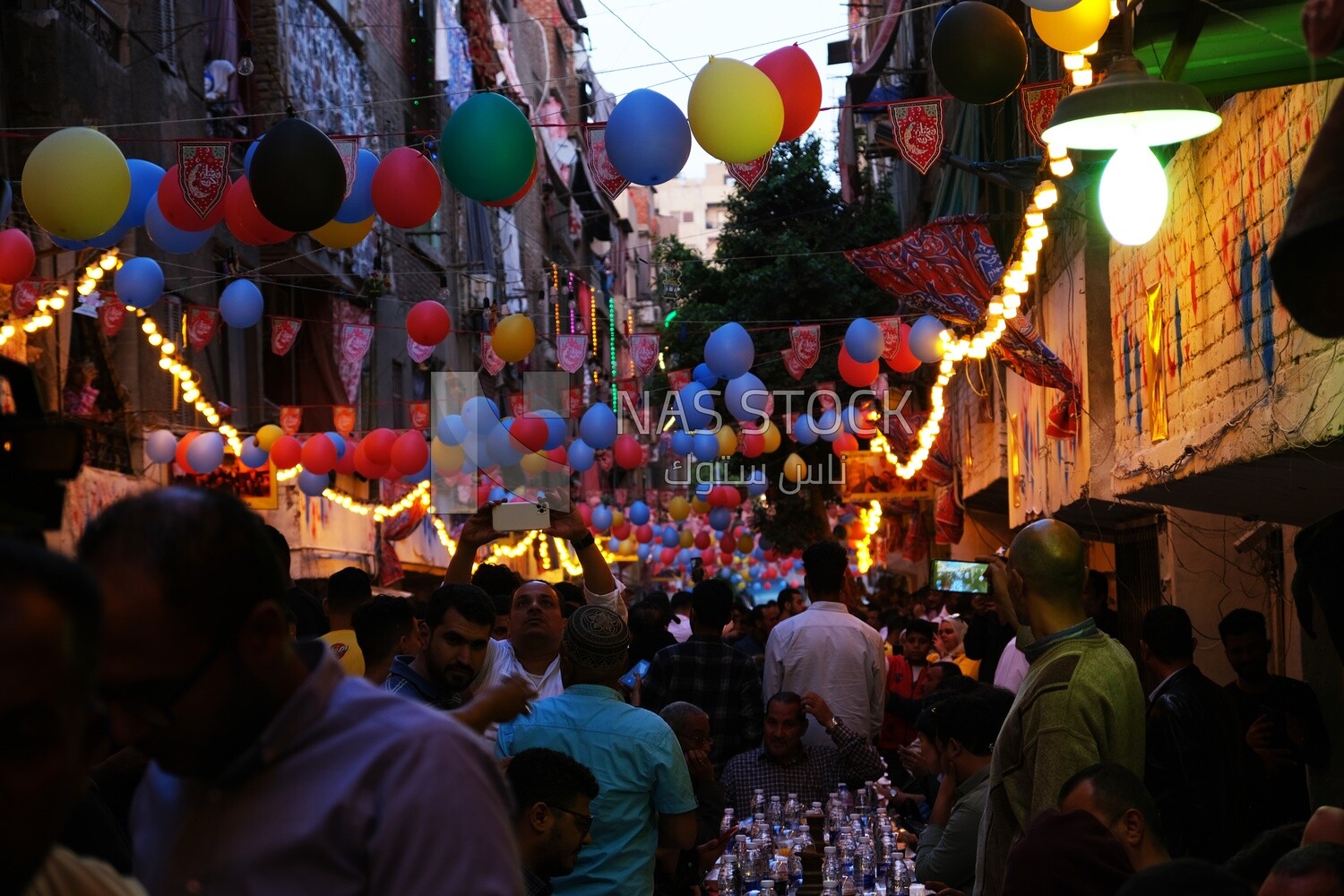 View of people in Matareya sharing their iftar together in the street, Ramadan Kareem, preparing their iftar