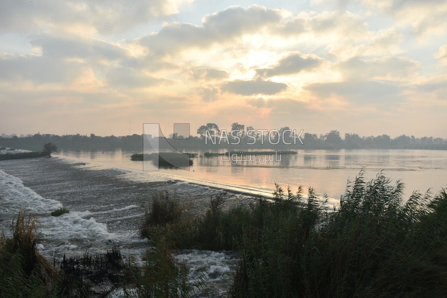 Wide area of the Nile River with sunrise and cloudy sky,Egypt